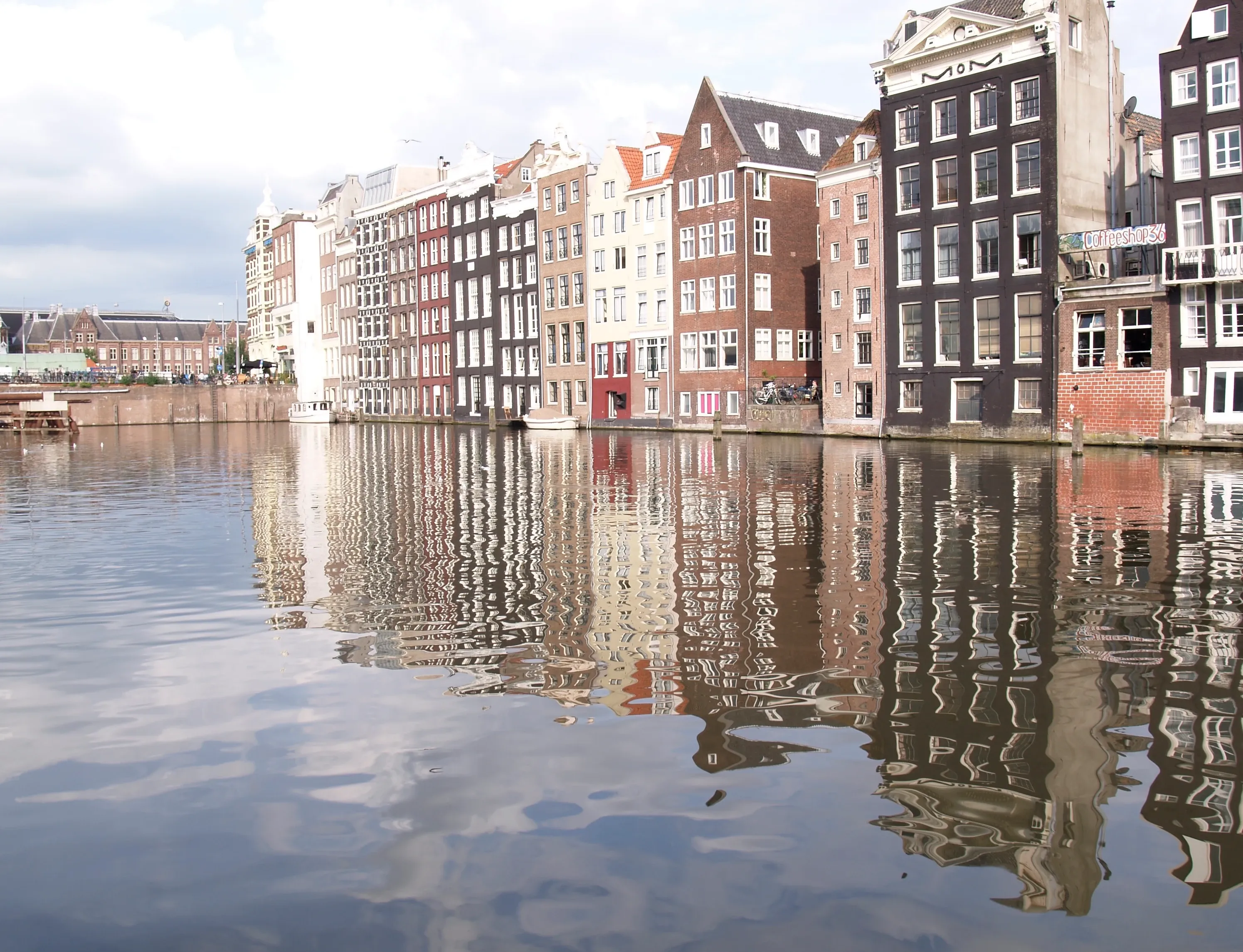 Photo of Damrak, Amsterdam: this stretch (rak) of water was once a part of the Amstel River in central Amsterdam; it was dammed and the water plus the adjacent street are called Damrak. 
